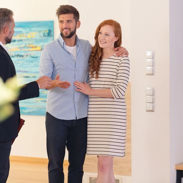 A man in duty explaining to Couple