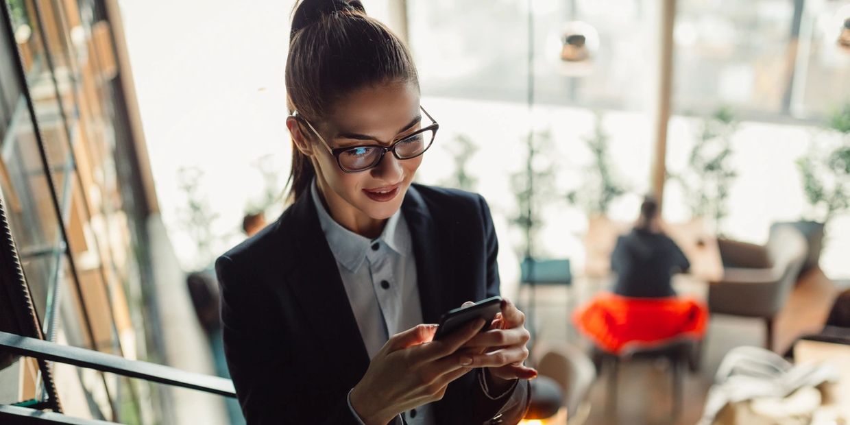 Marketing consultant looking at social media on a mobile device