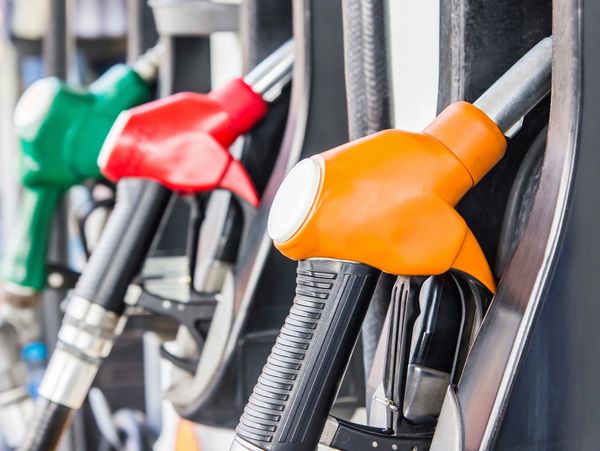 Close-up of colorful fuel pump nozzles at a gas station.