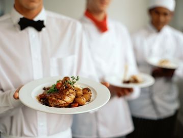 Staff serving plated food