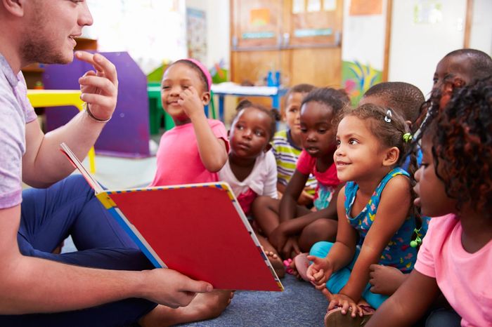 female teacher teaching children in child care class