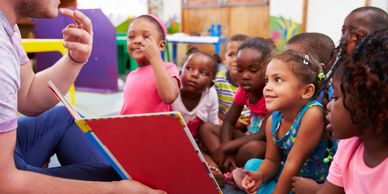 Child Care Teachers make the world a better place. Teacher with students during circle time.