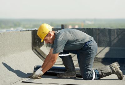 Man working on roof repairs