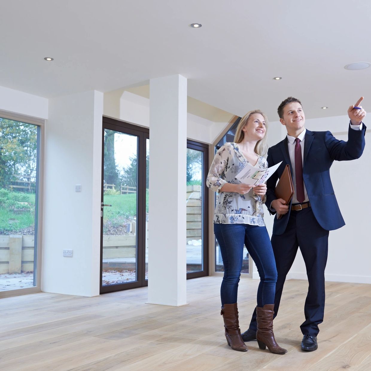 Real estate agent showing a woman a house.