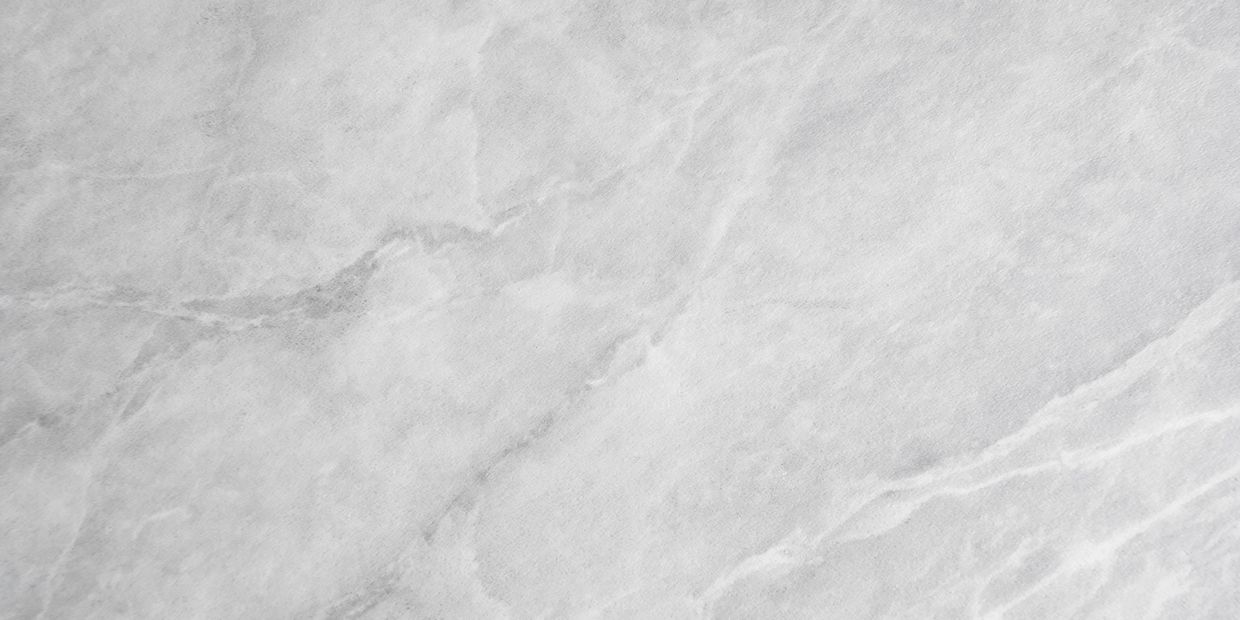 Close-up of a light gray marble surface with natural veining.