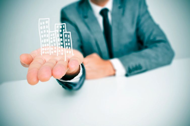 Businessman Presenting a Building Concept