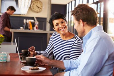 man and woman having a meeting in a coffee shop