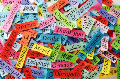 Colorful notes with 'Thank you' in many languages.