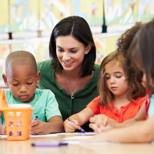 Teacher with children engaged in expressing their ideas