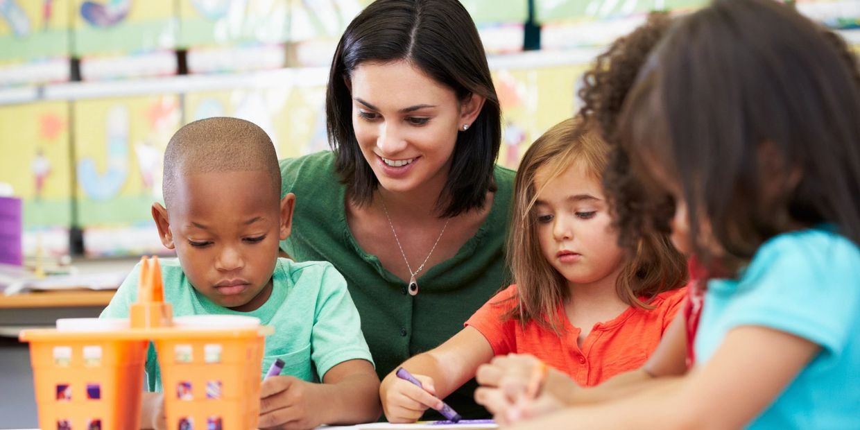 Children learning at daycare with their teacher