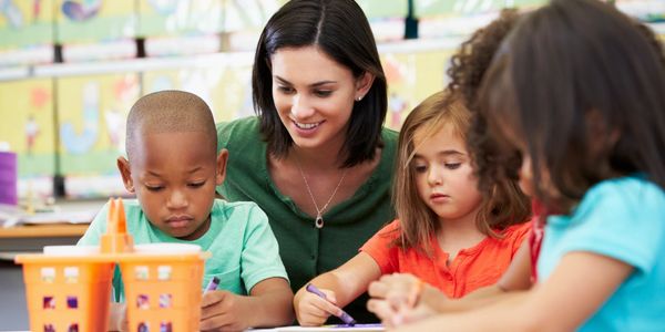 teacher with students coloring