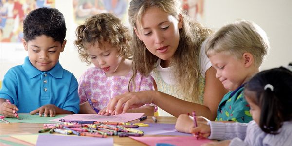 children with teacher at daycare