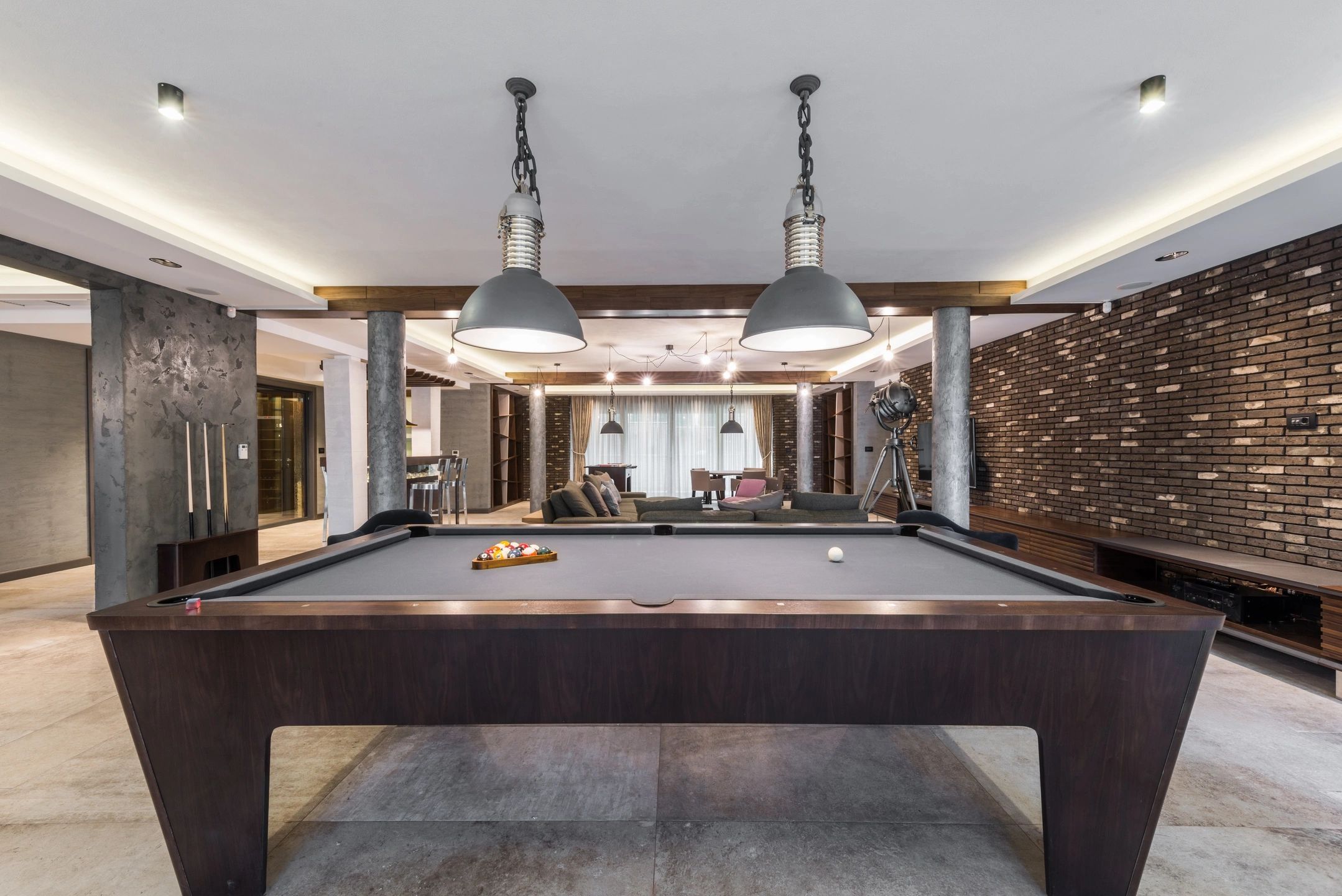 Finished basement with pool table and lights