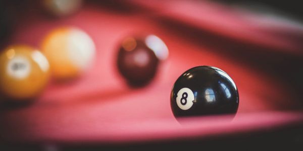 playing pool billiard balls on green felt table.