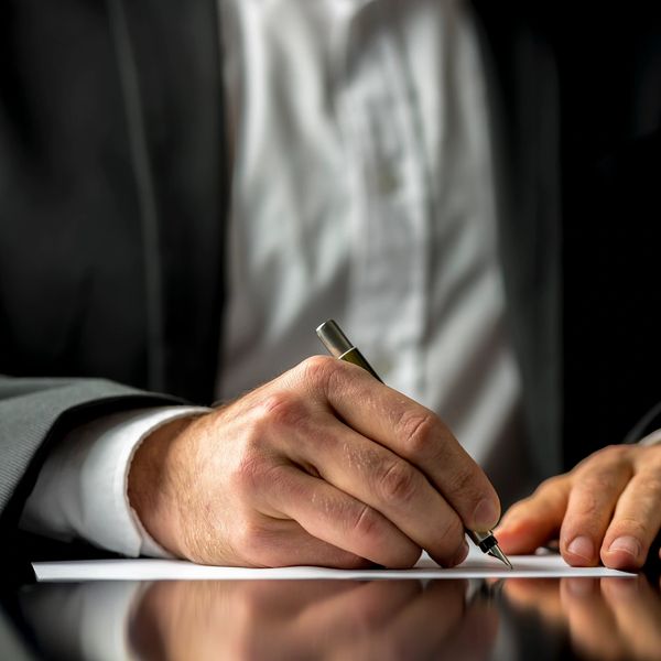 A man writing on paper