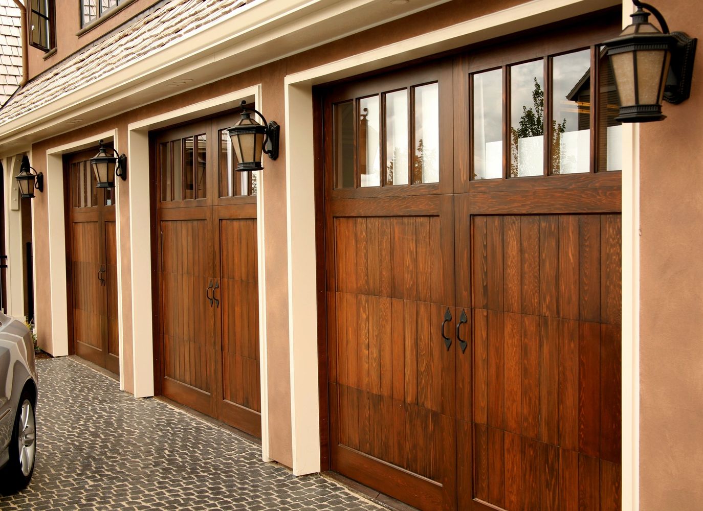 Multiple wood grain garage doors with windows