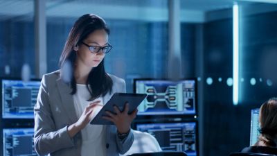Woman using tablet in a modern office environment.