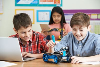 Robotics and coding class - kids with laptop and robot