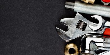 Various metal tools on a dark background.