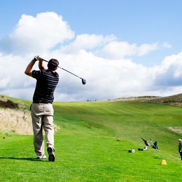 Golfer swing club after improving swing through physical therapy