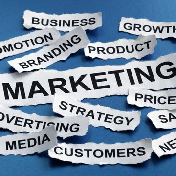 Torn paper pieces with marketing-related words on a blue background.