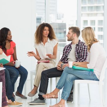 Woman speaking to three other people.