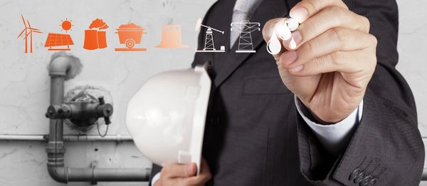 Engineer planning energy solutions with various power icons above.