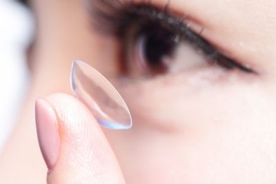 Woman putting a contact lens in the eye