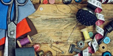 Sewing supplies on wooden surface.