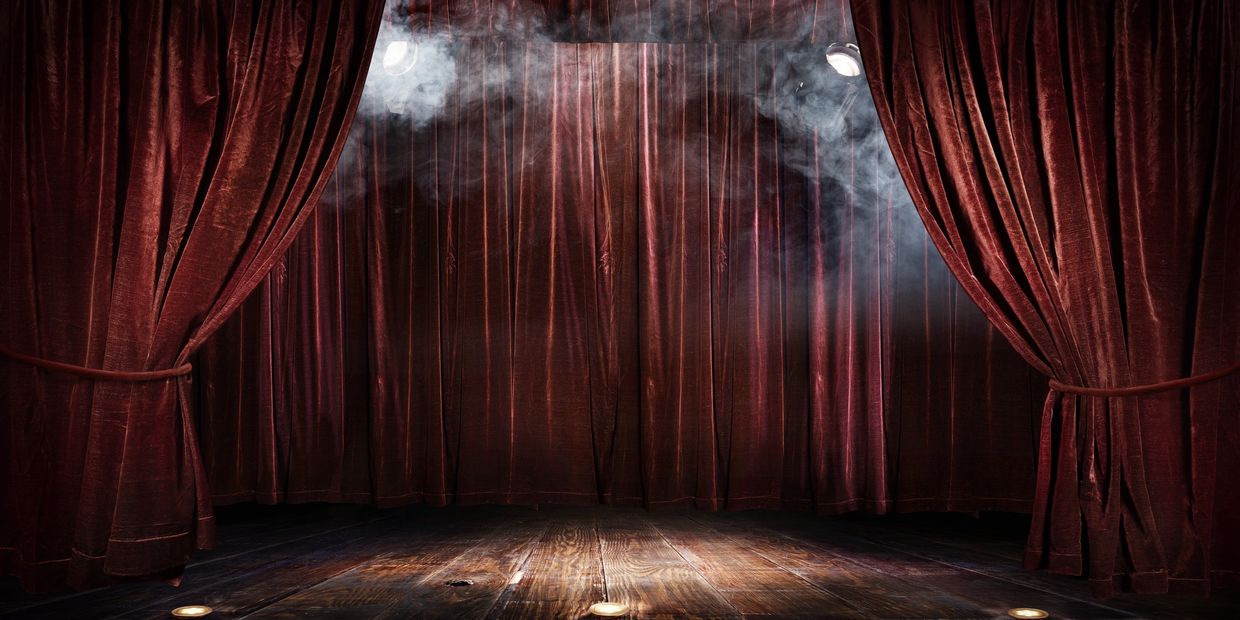 A stage with smoke and curtains 