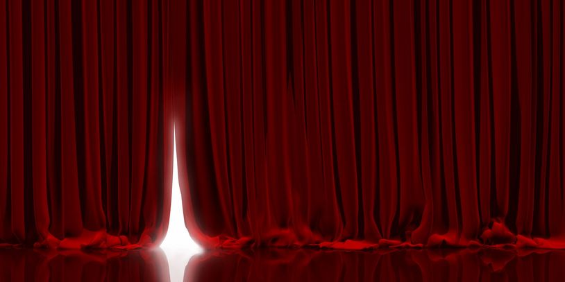 red color curtains of the stage with a little open passage 