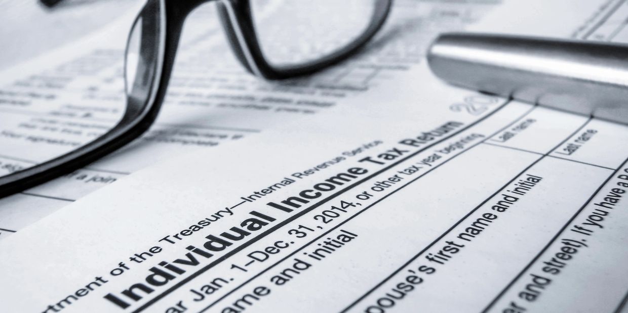 close up of documents with glasses laying on top