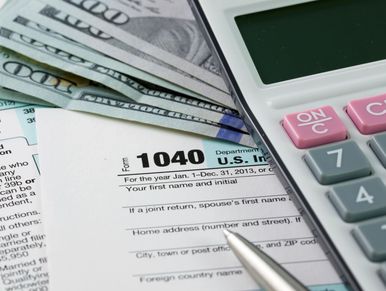 U.S. tax form 1040 with calculator and currency.