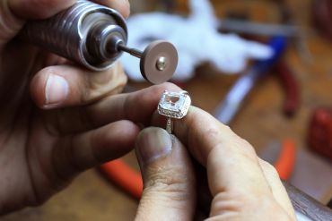 Jeweler polishing a diamond ring.