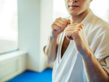 Person in martial arts stance wearing a gi.
