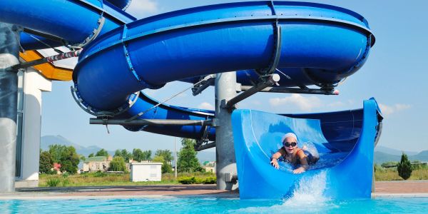 Child enjoying a blue water slide.