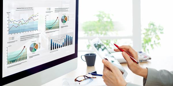 A lady looking at data visualisations on her computer screen.