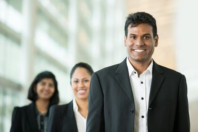 A picture of three business professionals smiling