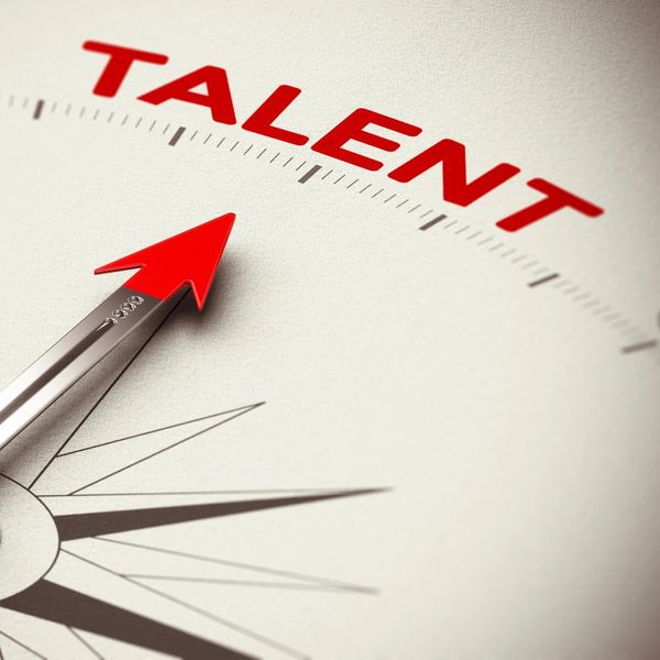 Compass needle pointing to the word "TALENT" in bold red letters.