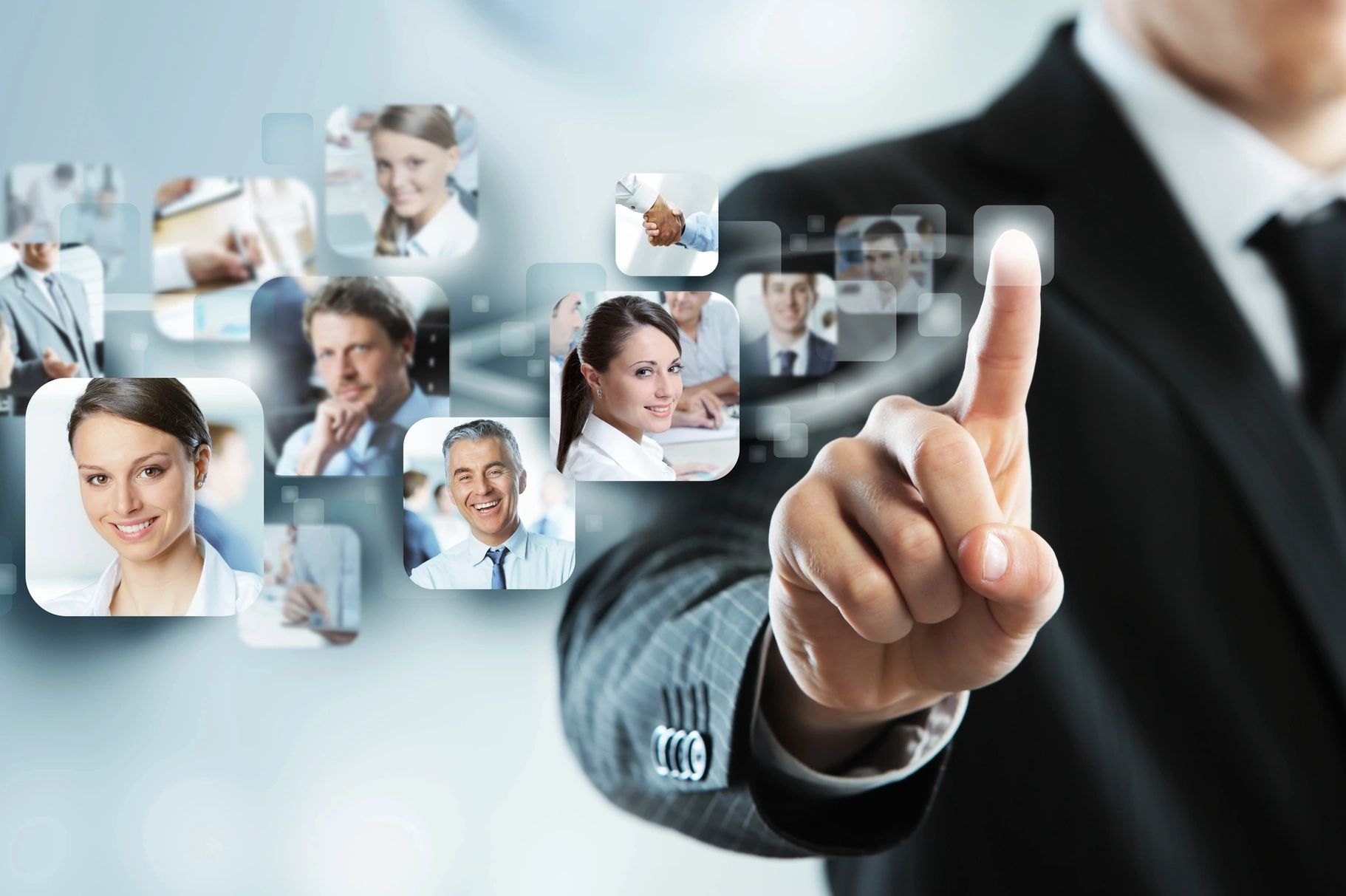 Businessman interacting with virtual network of professional portraits.