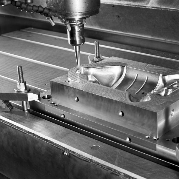 CNC milling machine shaping a metal mold with precision.