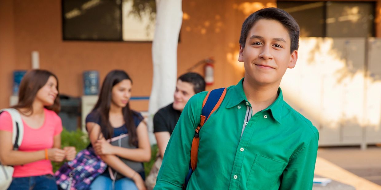 teenage boy with backpack at school