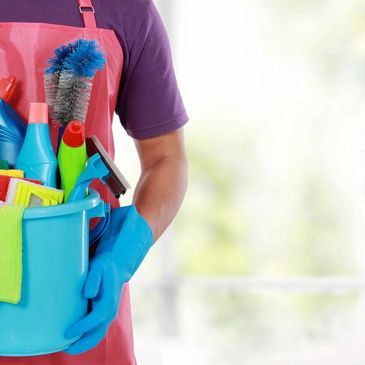 Woman holding bucket of cleaning supplies