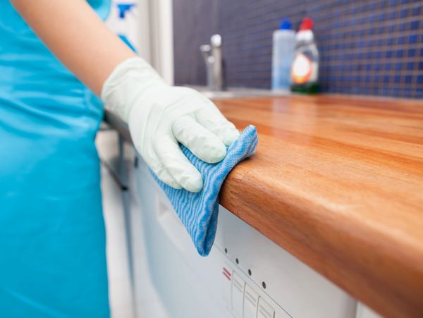 a woman cleaning a kitchen