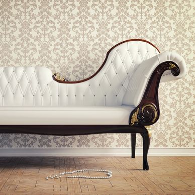 Elegant white leather vintage sofa with carved wood and gold accents.
