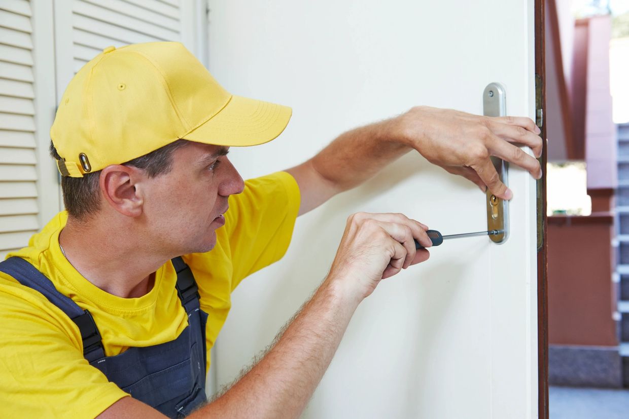 handyman repairing door lock