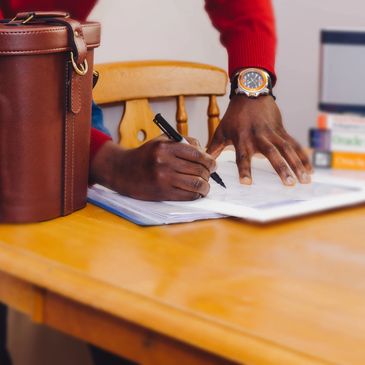 A woman signing on a document