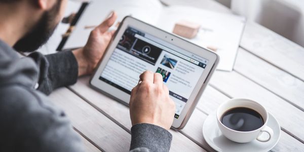 man using tablet connected to WiFi