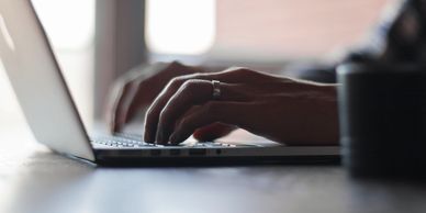 Photo of man typing on laptop