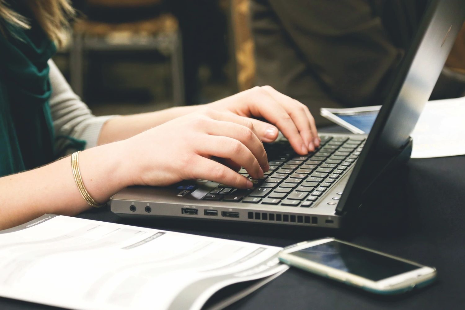 A person typing on a laptop computer.